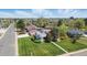 Aerial view of a charming home with a well-kept lawn, mature trees, and easy access to nearby streets at 1400 S Knox Ct, Denver, CO 80219