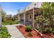 Inviting covered back patio with wrought iron posts and flowering plants at 1400 S Knox Ct, Denver, CO 80219