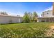 A lush backyard featuring a detached garage, and a grassy area perfect for outdoor activities at 1400 S Knox Ct, Denver, CO 80219