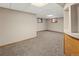 Spacious basement area with carpet and two windows allowing natural light at 1400 S Knox Ct, Denver, CO 80219