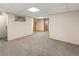 Spacious finished basement area with plush carpeting and neutral walls at 1400 S Knox Ct, Denver, CO 80219