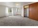 Spacious bedroom with gray carpet, closet, windows, and natural light at 1400 S Knox Ct, Denver, CO 80219