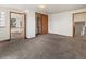 Large bedroom with neutral carpet, closet, and two doorways to other rooms; a light and airy space at 1400 S Knox Ct, Denver, CO 80219