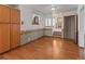 Cozy dining room with hardwood floors, built-in cabinet, and a view of the living room at 1400 S Knox Ct, Denver, CO 80219