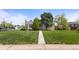 Charming home with a manicured lawn and mature trees at 1400 S Knox Ct, Denver, CO 80219