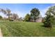 Well-maintained home with a spacious front yard and mature landscaping at 1400 S Knox Ct, Denver, CO 80219