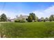 Charming home featuring lush green lawn and mature landscaping at 1400 S Knox Ct, Denver, CO 80219