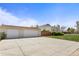 Two-car garage with wide driveway, against blue skies at 1400 S Knox Ct, Denver, CO 80219