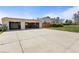 Large driveway leads to the spacious 2-car garage with overhead doors and ample parking at 1400 S Knox Ct, Denver, CO 80219