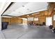 Spacious two-car garage features exposed rafters, concrete floors, and plenty of room for storage or workshop at 1400 S Knox Ct, Denver, CO 80219