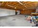 Spacious garage with high ceilings, wood frame construction, and ample lighting perfect for projects and storage at 1400 S Knox Ct, Denver, CO 80219