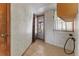 Functional laundry room with tile flooring, vintage decor and exterior door at 1400 S Knox Ct, Denver, CO 80219