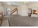 Open living room with plush carpeting, vintage ceiling fans, and curved archways at 1400 S Knox Ct, Denver, CO 80219