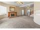 Bright living room features a fireplace, neutral carpet, and large windows at 1400 S Knox Ct, Denver, CO 80219