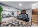 Cozy basement featuring plush seating, a treadmill, and stairs to upper levels at 9170 Aspen Dr, Thornton, CO 80229