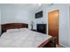 Inviting bedroom with wood-framed bed, mounted television, and an adjacent closet at 9170 Aspen Dr, Thornton, CO 80229