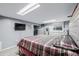 Bedroom with a queen-sized bed, matching dressers, and a wall mounted TV at 9170 Aspen Dr, Thornton, CO 80229