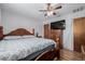 Spacious bedroom boasts a wooden bed frame, ceiling fan, and mounted television at 9170 Aspen Dr, Thornton, CO 80229