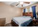Comfortable bedroom displays wood-framed bed, wood floors, and natural lighting from a window at 9170 Aspen Dr, Thornton, CO 80229