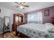 Charming bedroom with an antique dresser, wood floors, and window with sheer curtains at 9170 Aspen Dr, Thornton, CO 80229