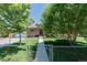 Inviting front yard featuring lush trees, a vibrant green lawn, and a charming brick home at 9170 Aspen Dr, Thornton, CO 80229
