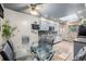 Bright kitchen featuring gray cabinets, stainless steel appliances, modern backsplash, and a spacious dining area at 9170 Aspen Dr, Thornton, CO 80229