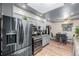 Modern kitchen boasts stainless steel appliances, gray cabinets, and a seamless flow into the adjacent dining area at 9170 Aspen Dr, Thornton, CO 80229