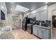 Stylish kitchen with gray cabinets, stainless steel appliances, granite countertops and wood-look floors at 9170 Aspen Dr, Thornton, CO 80229