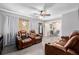 Inviting living room showcasing wood floors, recliners, and view into the dining area at 9170 Aspen Dr, Thornton, CO 80229