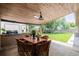 Back yard outdoor patio features wooden ceiling and seating near a lush, grassy yard at 9170 Aspen Dr, Thornton, CO 80229
