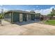 Outside of property with sliding glass doors, yard and large driveway at 5556 Vaughn St, Denver, CO 80239