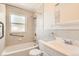 A well-lit bathroom with a shower-tub combination and grab bars for added safety and convenience at 5556 Vaughn St, Denver, CO 80239