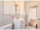 A cozy bathroom featuring a white vanity, tiled walls, and ample lighting for a fresh, clean feel at 5556 Vaughn St, Denver, CO 80239