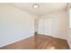 Bright bedroom featuring hardwood floors, fresh paint, and a closet at 5556 Vaughn St, Denver, CO 80239