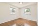 Bedroom featuring hardwood floors and two windows, providing ample natural light at 5556 Vaughn St, Denver, CO 80239