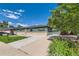 Cozy single-story home with a well-maintained lawn and concrete driveway, complemented by mature trees at 5556 Vaughn St, Denver, CO 80239