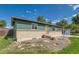 Single Gathering home with brick accents, mature trees, and 'For Sale' sign in the front yard at 5556 Vaughn St, Denver, CO 80239