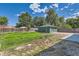 Exterior shot of backyard showing green grass and detached garage with driveway at 5556 Vaughn St, Denver, CO 80239
