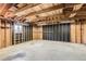 Spacious unfinished garage with exposed wooden beams and framing at 5556 Vaughn St, Denver, CO 80239