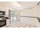 Bright kitchen features white cabinets, black appliances, and a sliding glass door at 5556 Vaughn St, Denver, CO 80239