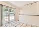 Bright kitchen featuring sliding glass doors and tiled floors provides backyard access at 5556 Vaughn St, Denver, CO 80239