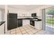 Kitchen featuring tiled floor and stainless appliances, with access to outdoor space at 5556 Vaughn St, Denver, CO 80239