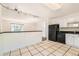 Bright kitchen showcasing white cabinets, black appliances, and tiled floors at 5556 Vaughn St, Denver, CO 80239