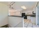 The kitchen has white cabinets and black appliances with room to cook and entertain at 5556 Vaughn St, Denver, CO 80239