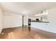 Bright living space with hardwood floors, white walls, and an open view of the kitchen at 5556 Vaughn St, Denver, CO 80239
