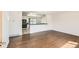 Open-concept living area with wood floors flowing into a modern kitchen with white cabinets at 5556 Vaughn St, Denver, CO 80239