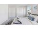 Serene bedroom with plush bedding, ample closet space, and natural light streaming through the window at 2430 Eaton St, Edgewater, CO 80214