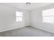 Bedroom featuring two windows and neutral carpeting, offering a bright, adaptable space at 2430 Eaton St, Edgewater, CO 80214