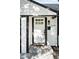 Inviting entryway featuring a white door with grid window and a black door frame at 2430 Eaton St, Edgewater, CO 80214