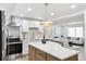 Modern kitchen featuring white cabinets, countertops, and stainless steel appliances at 2430 Eaton St, Edgewater, CO 80214